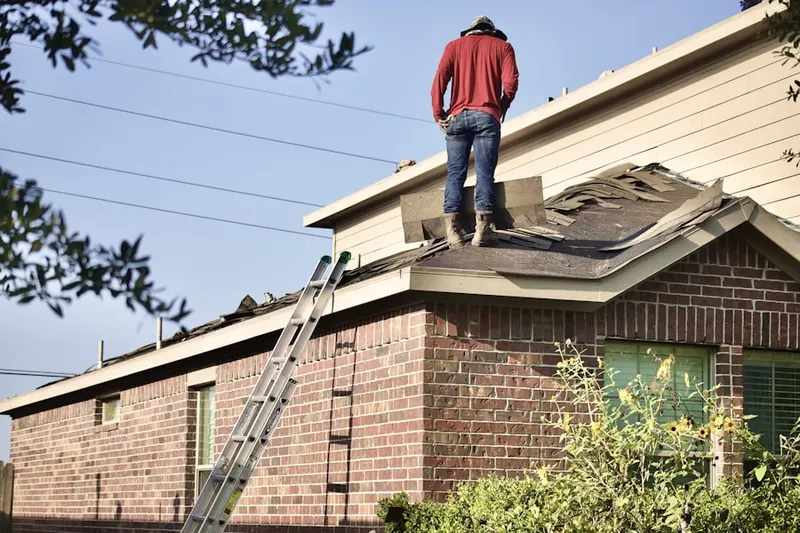 Professional roofer working on a residential roof in Linden Estates